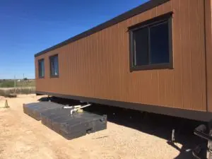 A trailer with a dog sitting on top of it.