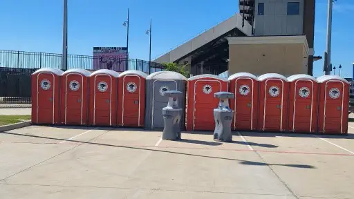 A group of portable toilets sitting next to each other.