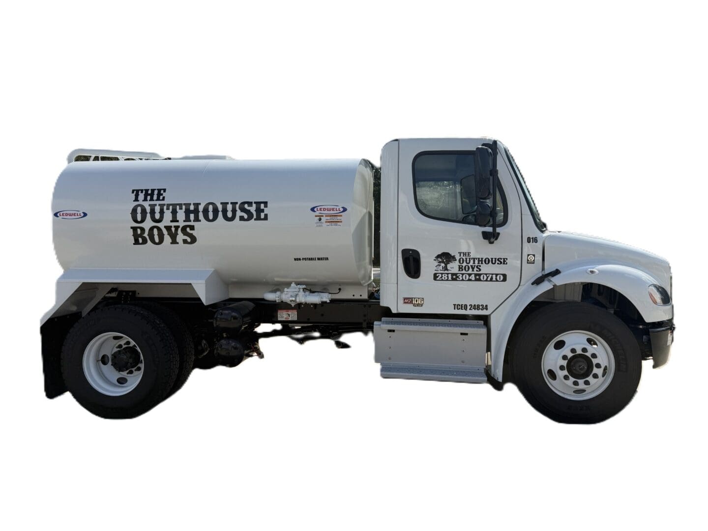 White septic service truck, "The Outhouse Boys".